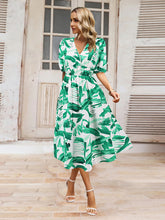 Load image into Gallery viewer, Ruched Printed Surplice Short Sleeve Dress
